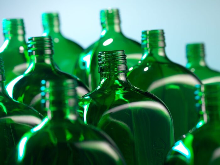 Top of multiple green glass bottles